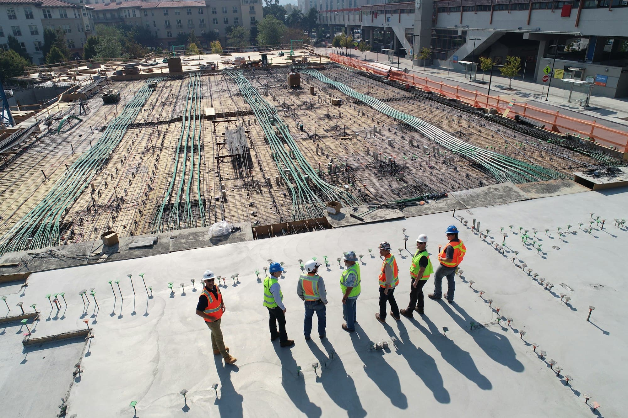 Large commercial construction site with structural steel and concrete works